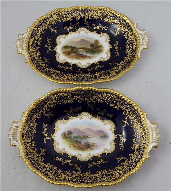 A Coalport named view plate and a pair of matching dessert dishes, c.1900, 26.5cm and 28cm